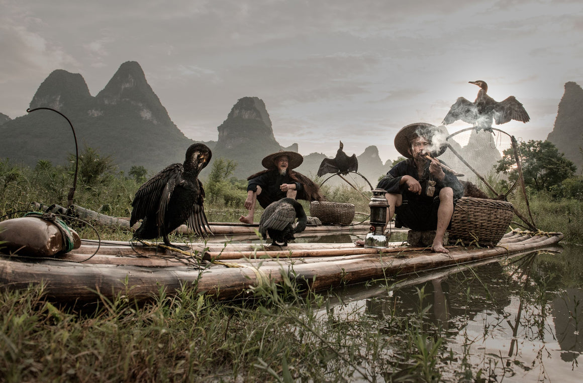 fishermen float bamboo rafts along the river