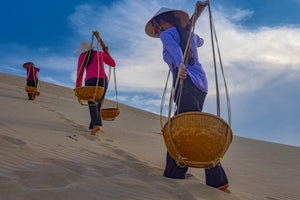 Champa women carrying goods on the silky soft sand dunes