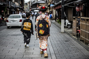 Maiko going to work on the streets of Kyoto